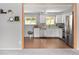 Charming kitchen with stainless steel appliances, white cabinets and wood-look flooring at 6353 W 78Th Ave, Arvada, CO 80003