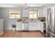 Bright kitchen with stainless steel appliances, white cabinets and wood-look flooring at 6353 W 78Th Ave, Arvada, CO 80003