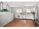 Bright kitchen with stainless steel appliances, white cabinets, and hardwood floors at 6353 W 78Th Ave, Arvada, CO 80003