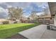 Large backyard featuring healthy lawn, perimeter landscaping, and concrete patio at 2076 S Yates St, Denver, CO 80219