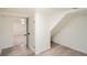 Basement storage area featuring vinyl floors, stairs, and view to finished carpeted room at 2076 S Yates St, Denver, CO 80219