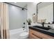 Bathroom with modern vanity, black fixtures, and a shower-tub combination at 2076 S Yates St, Denver, CO 80219