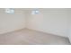 Neutral bedroom featuring plush carpet and two windows with plenty of natural light at 2076 S Yates St, Denver, CO 80219