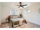 Cozy bedroom with a ceiling fan, neutral decor and natural light from two windows at 2076 S Yates St, Denver, CO 80219