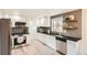 Bright kitchen with white cabinets, modern appliances, granite countertops, and decorative backsplash at 2076 S Yates St, Denver, CO 80219