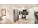 Modern kitchen featuring stainless steel appliances, white cabinetry, and updated countertops and flooring at 2076 S Yates St, Denver, CO 80219