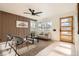 Bright living room with modern wood wall accents, stylish seating, and lots of natural light coming through the large window at 2076 S Yates St, Denver, CO 80219