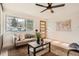 Inviting living room filled with natural light from a large window, showcasing modern furnishings and an inviting atmosphere at 2076 S Yates St, Denver, CO 80219