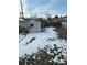 Snowy backyard with a small white shed, partial snow cover, and fencing around the perimeter at 2619 S Bannock St, Denver, CO 80223