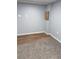 Basement area featuring neutral walls, and a mix of carpeting and laminate flooring, offering versatile potential at 2619 S Bannock St, Denver, CO 80223