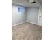 Basement area with neutral walls, carpeting, and a small window, offering a versatile space for various uses at 2619 S Bannock St, Denver, CO 80223
