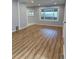 Bright living room with wood laminate floors and neutral walls at 2619 S Bannock St, Denver, CO 80223