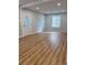 Open-concept living area featuring laminate flooring and neutral walls and trim at 2619 S Bannock St, Denver, CO 80223