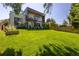 Expansive backyard with lush green lawn, patio area with seating, and mature trees, perfect for outdoor relaxation and entertainment at 3485 S Clermont St, Denver, CO 80222