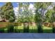 A lush, green backyard with a wood fence, mature trees, and manicured lawn at 3485 S Clermont St, Denver, CO 80222