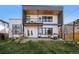 Modern home with backyard featuring a covered patio and landscaped yard at 3485 S Clermont St, Denver, CO 80222