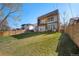 Large backyard with a patio, green grass, a modern deck, and an outdoor dining set at 3485 S Clermont St, Denver, CO 80222
