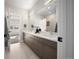 Bright bathroom with double vanity, large mirror, and tile flooring at 3485 S Clermont St, Denver, CO 80222