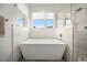 Bathroom featuring a luxurious square soaking tub and glass shower at 3485 S Clermont St, Denver, CO 80222
