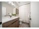 Well-lit bathroom with modern vanity, framed mirror, and decorative accents at 3485 S Clermont St, Denver, CO 80222