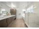 Bright bathroom featuring double sinks, white countertop, and a glass shower at 3485 S Clermont St, Denver, CO 80222