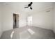 Airy bedroom with open doorways, neutral carpet and a ceiling fan at 3485 S Clermont St, Denver, CO 80222