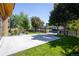 Wide concrete driveway leading to a landscaped property with mature trees, set against a backdrop of a quiet neighborhood street at 3485 S Clermont St, Denver, CO 80222