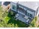 Modern home exterior with a balcony, patio seating, and well-maintained backyard at 3485 S Clermont St, Denver, CO 80222