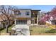 Contemporary two-story home with mixed materials, a driveway, modern garage door and a partially fenced front yard at 3485 S Clermont St, Denver, CO 80222