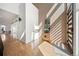 Bright and airy foyer featuring a brick wall, a wooden cabinet with a mirror and a hardwood floor at 3485 S Clermont St, Denver, CO 80222