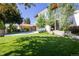 Modern home featuring a well-manicured front lawn, mature trees and an inviting entrance with stylish windows and landscaping at 3485 S Clermont St, Denver, CO 80222