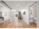 Open hallway with hardwood floors, a floating staircase and a modern powder room at 3485 S Clermont St, Denver, CO 80222