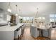 A gourmet kitchen with an island, stainless steel appliances and bright white walls at 3485 S Clermont St, Denver, CO 80222