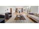 Bright open-concept living room with hardwood floors flowing into the gourmet kitchen and dining area at 3485 S Clermont St, Denver, CO 80222