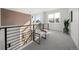 A bright loft with a high celling, light grey carpet, and railing at 3485 S Clermont St, Denver, CO 80222
