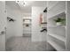 Bright walk-in closet with custom shelving, hanging rods and carpeted floor at 3485 S Clermont St, Denver, CO 80222