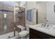 Elegant bathroom with a glass-enclosed shower, granite countertop, and modern fixtures at 5439 Verbena St, Denver, CO 80238