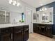 Well-lit bathroom featuring dual vanities, granite countertops, and a separate shower area at 5439 Verbena St, Denver, CO 80238