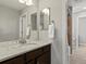 Bathroom with a large mirror and granite countertop, neutral paint, and an open doorway to a shower at 5439 Verbena St, Denver, CO 80238