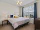 Cozy bedroom with a comfortable bed, a large window, and ample natural light at 5439 Verbena St, Denver, CO 80238