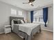 Serene bedroom with a comfortable bed, stylish decor, and a large window with natural light at 5439 Verbena St, Denver, CO 80238