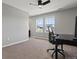 Bedroom with a carpet, large window with views, ceiling fan and light fixture, a desk, and an office chair at 5439 Verbena St, Denver, CO 80238