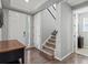 A welcoming foyer with staircase, hardwood floors, closet and lots of natural light from the window at 5439 Verbena St, Denver, CO 80238