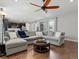 Spacious living room, open to the kitchen, with hardwood floors and a comfortable sectional sofa at 5439 Verbena St, Denver, CO 80238