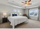 Spacious main bedroom featuring a tray ceiling, ceiling fan, and ample natural light at 5439 Verbena St, Denver, CO 80238