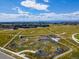 Aerial view of bike park with pump track and green space for outdoor recreation at 5439 Verbena St, Denver, CO 80238