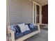 Inviting front porch with porch swing and comfortable pillows with the front door just steps away at 5439 Verbena St, Denver, CO 80238