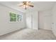 Bright bedroom featuring ceiling fan and neutral carpeting at 5547 S Lowell Blvd, Littleton, CO 80123