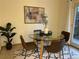 Dining area with glass table and four brown chairs at 5547 S Lowell Blvd, Littleton, CO 80123