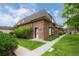 Brick townhouse with landscaping and walkway at 5547 S Lowell Blvd, Littleton, CO 80123